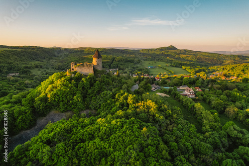 Ruins of a medieval castle Somoska or Somoskoi var on borders of southern Slovakia and Hungary at sunrise time. .Salgo Castle or Salgo vara in background