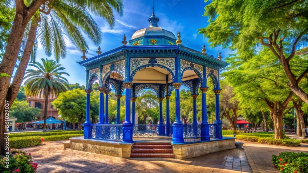 Vibrant blue afternoon at historic kiosk in Parque Central, Juchitan de Zaragoza, Oaxaca, with intricate architecture and lush greenery surrounding. Vibrant blue afternoon at historic kiosk in Parque Central, Juchitan de Zaragoza, Oaxaca, with intricate architecture and lush greenery surrounding.