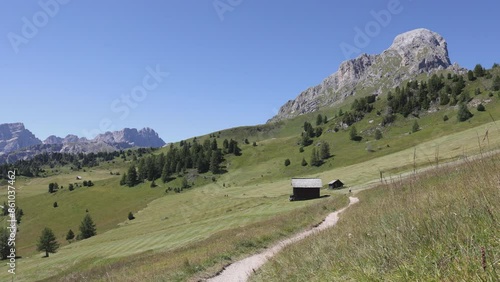 Open-air footpath among green meadows of Sas de Putia - Peitlerkofel in South Tyrol, Italy. High quality 4k footage photo