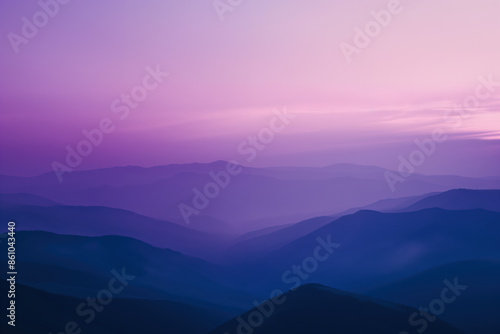 Purple mountain range fading into the distance during sunset © Edvvin
