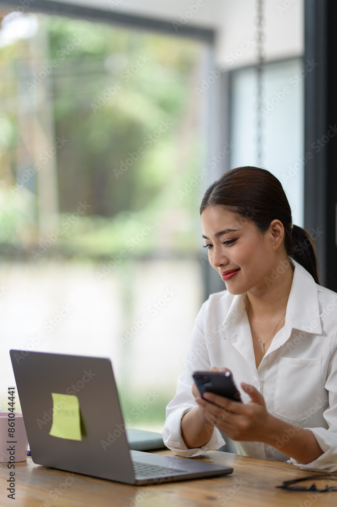 Asian businesswoman talking on the phone working in a modern office. Contacting customers. Customer manager, company sales. Contact online for finances startup business idea. Asian businesswoman talking on the phone working in a modern office. Contacting customers. Customer manager, company sales. Contact online for finances startup business idea.