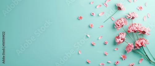 Pink flowers and petals on a turquoise background. Perfect for spring-themed designs, celebrations, or feminine aesthetics.