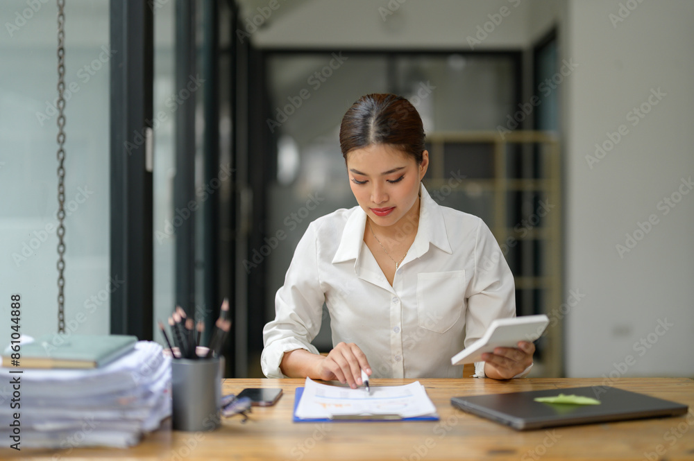 Asian businesswoman using calculator and laptop to do finance on office table, taxes, reports, accounting, online marketing Statistics and analytical research concepts startup business idea. Asian businesswoman using calculator and laptop to do finance on office table, taxes, reports, accounting, online marketing Statistics and analytical research concepts startup business idea.