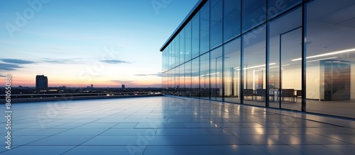 Evening view of a contemporary office building with clear sky, suitable as a copy space image.