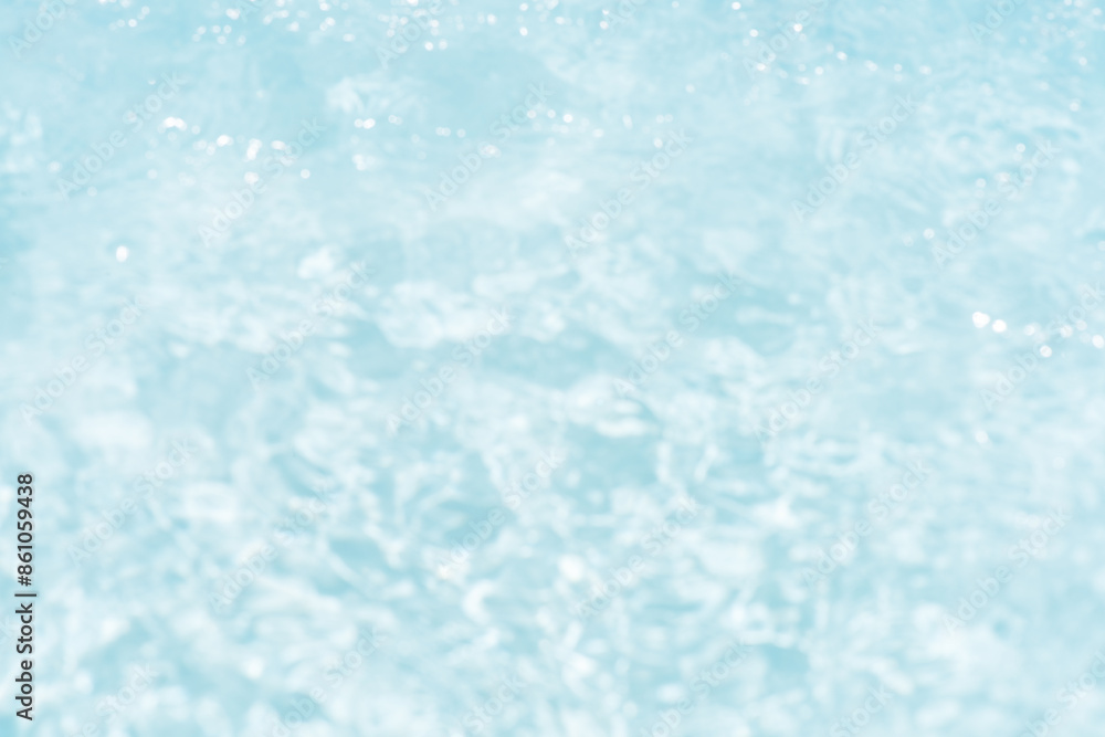 Obraz premium Blue water with ripples on the surface. Defocus blurred transparent blue colored clear calm water surface texture with splashes and bubbles. Water waves with shining pattern texture background.