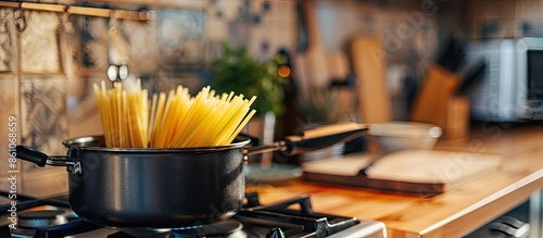 Pot with uncooked pasta and...