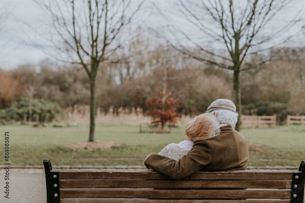 Fototapeta premium Lovely old couple on park bench background