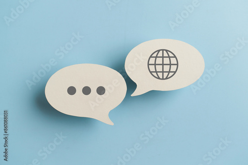 For translator application,  foreign languages concept, top view of real  white speech bubble paper with  on blue background