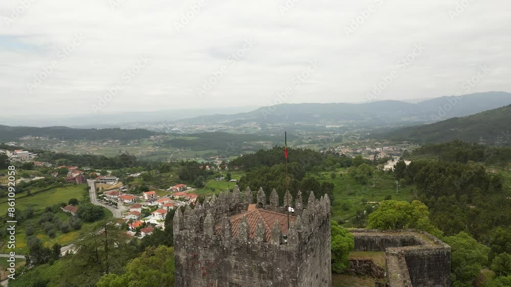 Aerial view of Castelo de Lanhoso with lush valleys and distant mountains in Portugal. Aerial view of Castelo de Lanhoso with lush valleys and distant mountains in Portugal.