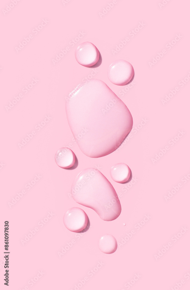 round drops of transparent gel serum on pink background round drops of transparent gel serum on pink background