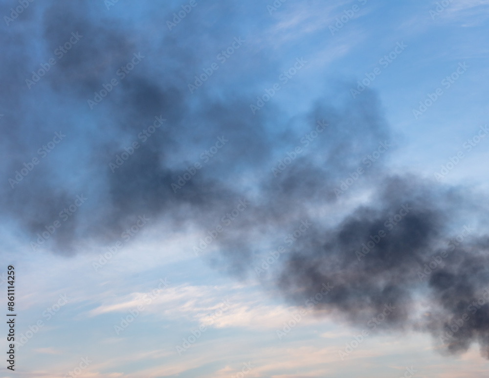 Black smoke from a fire against the sky Black smoke from a fire against the sky
