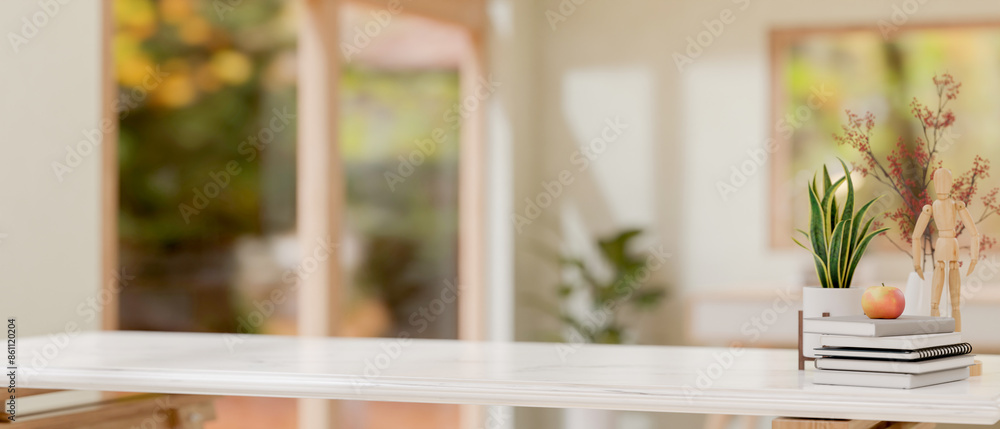 Fototapeta premium A white tabletop features decorative objects with a blurred background of a minimalist room.