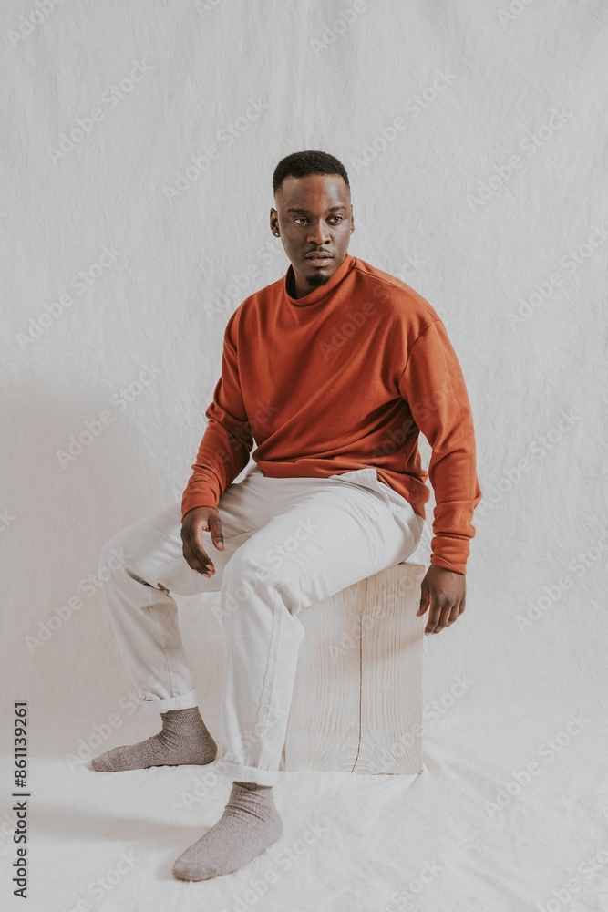 Man in orange long sleeve and beige pants, autumn apparel fashion design Man in orange long sleeve and beige pants, autumn apparel fashion design