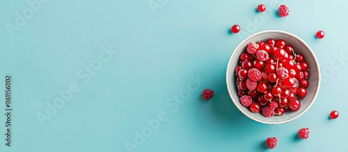 Fototapeta Naklejka Na Ścianę i Meble -  cereals bowl with red fruits isolated over pastel background. Copy space image. Place for adding text and design