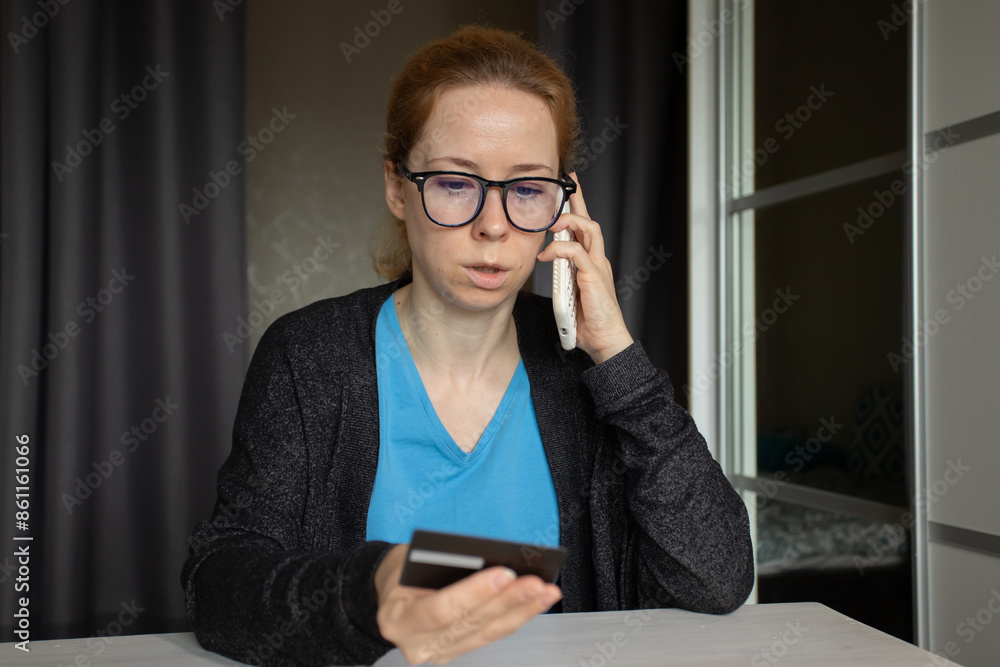 Victim of phone scammers, shocked woman with smartphone and credit card at home, cyber theft and mobile security issues. Victim of phone scammers, shocked woman with smartphone and credit card at home, cyber theft and mobile security issues.