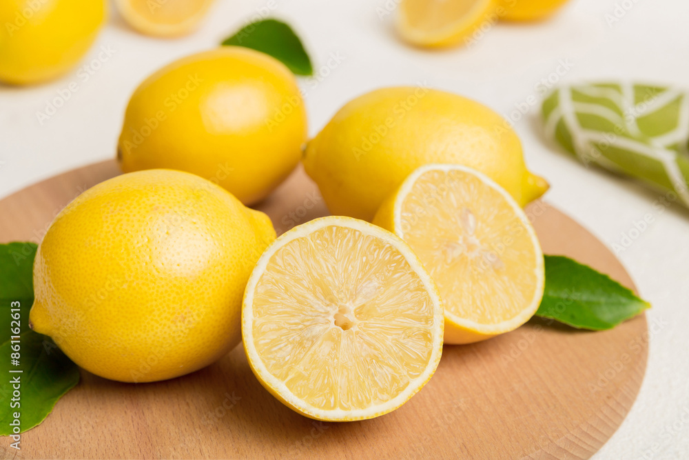 Top view with copy space for fresh and ripe lemons on cutting board. Healthy food background. Elegant background of lemon and lemon slices with squeezer colored background Top view with copy space for fresh and ripe lemons on cutting board. Healthy food background. Elegant background of lemon and lemon slices with squeezer colored background