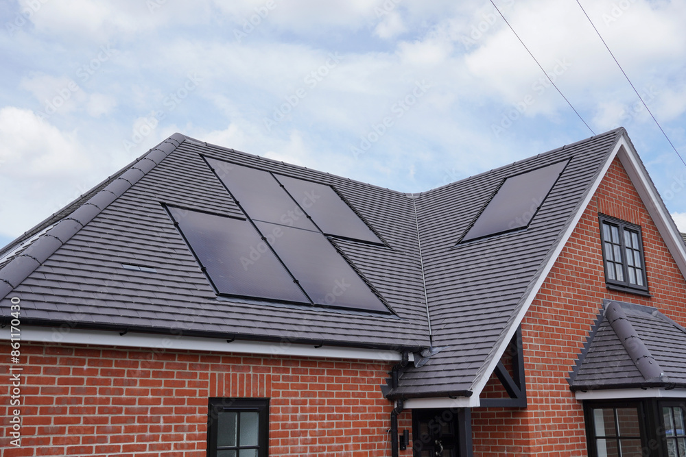 new build house with solar panels installed on roof. residential property with photovoltaic solar cells. sustainable energy source new build house with solar panels installed on roof. residential property with photovoltaic solar cells. sustainable energy source
