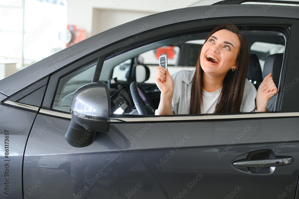 Happy woman with car key sitting in modern auto. Banner design Happy woman with car key sitting in modern auto. Banner design