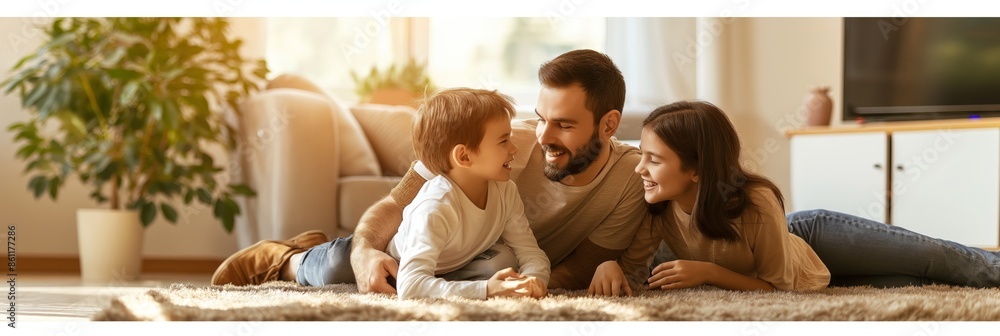 A family of three, including two adults and one child, lying on the floor at home, laughing and enjoying themselves in a cozy setting.
