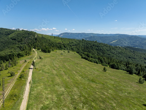 Polish green mountains and hills aerial drone photo.Drone fly above green mountains in summer. Drone view in Beskid mountains, Blatnia. Summer green forest on Blatnia. Beskid mountains in Jaworze. photo