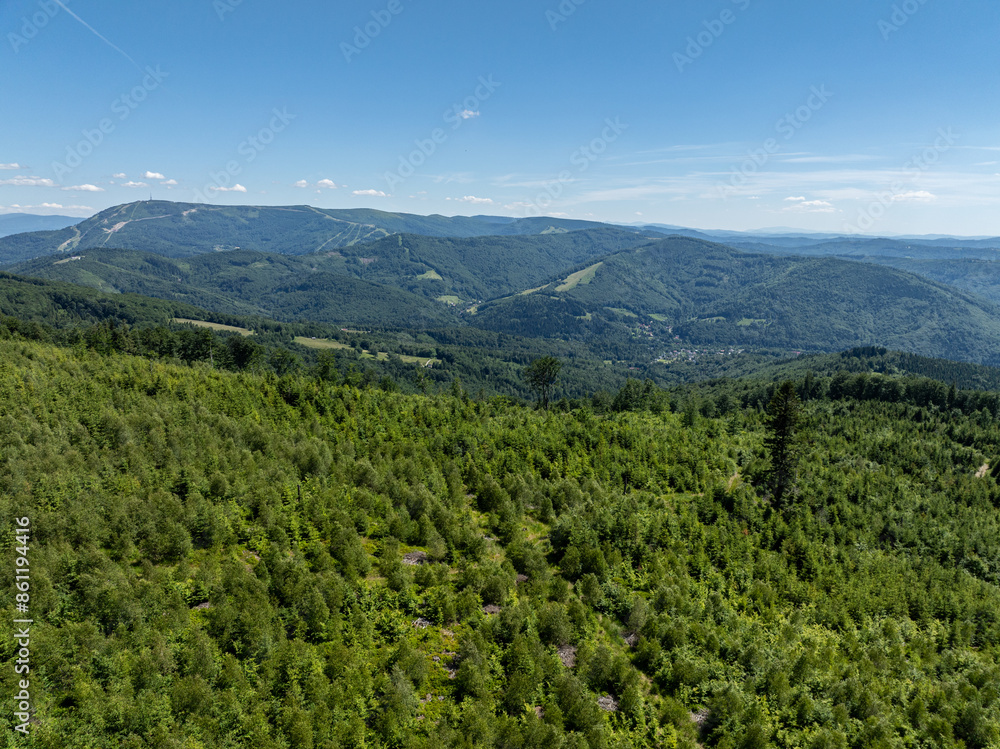 Drone fly above green mountains in summer. Polish green mountains and hills aerial drone photo. Drone view in Beskid mountains, Blatnia. Summer green forest on Blatnia. Beskid mountains in Jaworze. Drone fly above green mountains in summer. Polish green mountains and hills aerial drone photo. Drone view in Beskid mountains, Blatnia. Summer green forest on Blatnia. Beskid mountains in Jaworze.