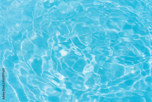 Blue water with ripples on the surface. Defocus blurred transparent blue colored clear calm water surface texture with splashes and bubbles. Water waves with shining pattern texture background.