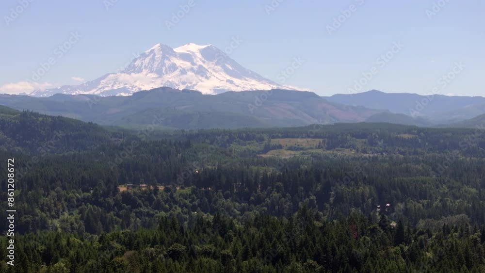Majestic Mount Rainier Rising Above Verdant Valley on a Clear Day Majestic Mount Rainier Rising Above Verdant Valley on a Clear Day