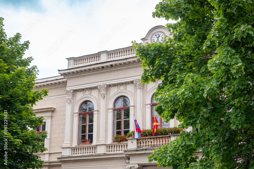 Slovak flag on a historical building next to which is a red flag with a yellow cross. Slovak flag on a historical building next to which is a red flag with a yellow cross.