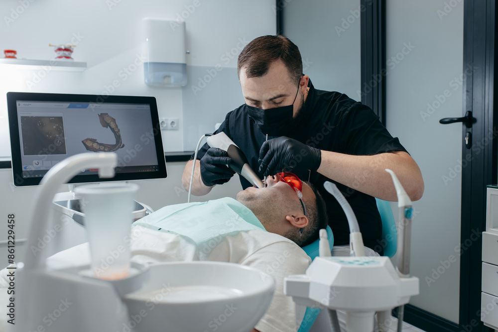 Dentist scanning teeth of male patient with modern scanning 3d machine Dentist scanning teeth of male patient with modern scanning 3d machine