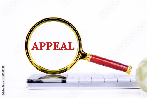 Concept of appeal or in the court of appeal. A word APPEAL through the lens of a magnifying glass on a light background photo