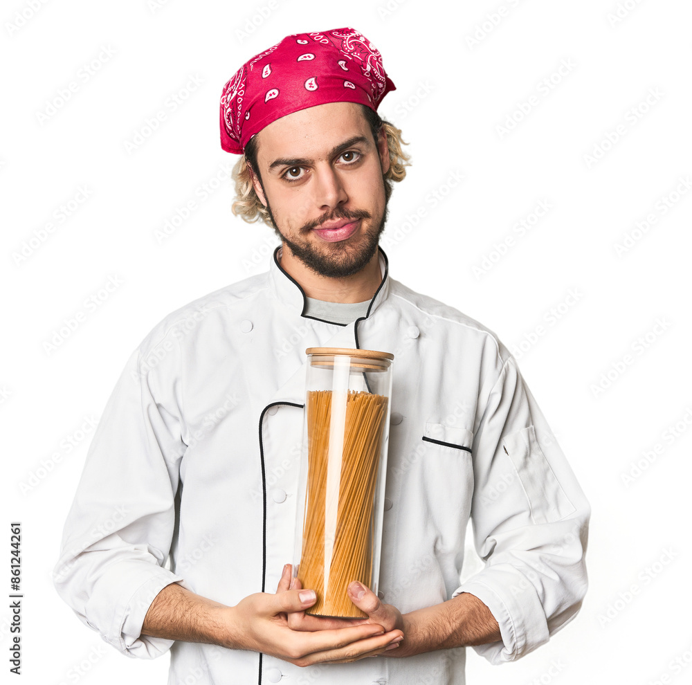 Young chef holds pasta sauce jar in studio happy, smiling and cheerful. Young chef holds pasta sauce jar in studio happy, smiling and cheerful.