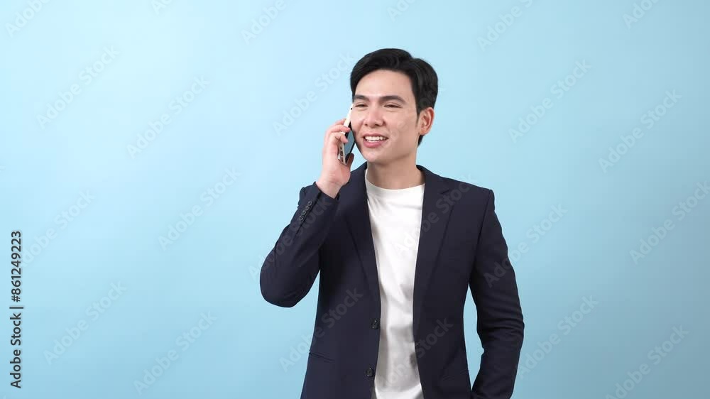 Young Asian businessman on blue background Young Asian businessman on blue background