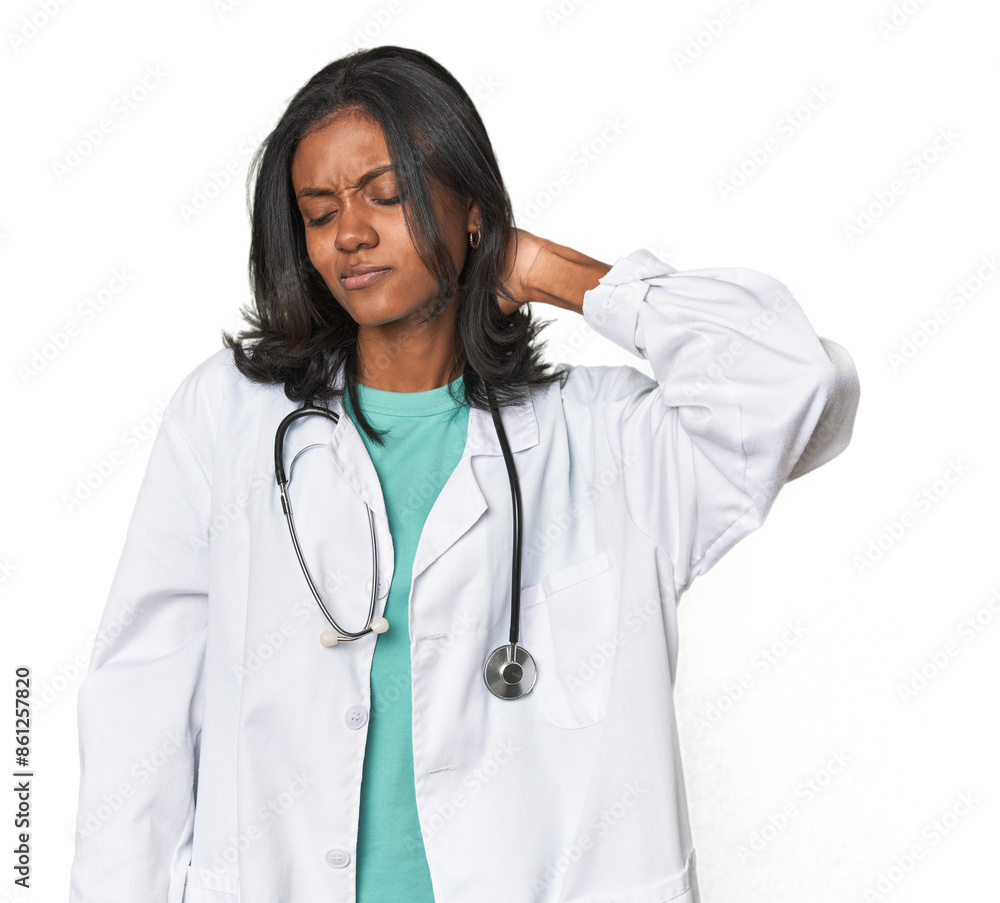 Young Indian doctor with stethoscope suffering neck pain due to sedentary lifestyle. Young Indian doctor with stethoscope suffering neck pain due to sedentary lifestyle.