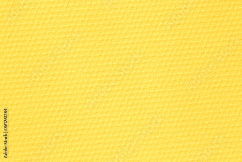 close up of yellow paper textured as honeycombs