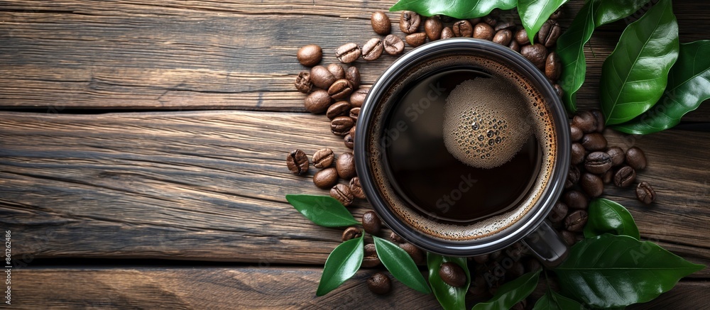 Top view of a mug of invigorating black coffee and coffee beans on a wooden background, with space for a label. Concept of hot drinks.
Top view of a mug of invigorating black coffee and coffee beans on a wooden background, with space for a label. Concept of hot drinks.