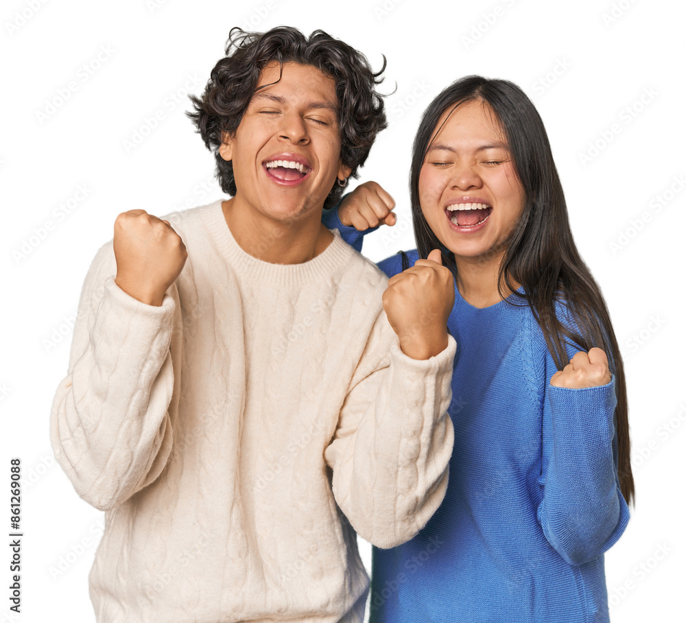 Young interracial couple in studio cheering carefree and excited. Victory concept. Young interracial couple in studio cheering carefree and excited. Victory concept.