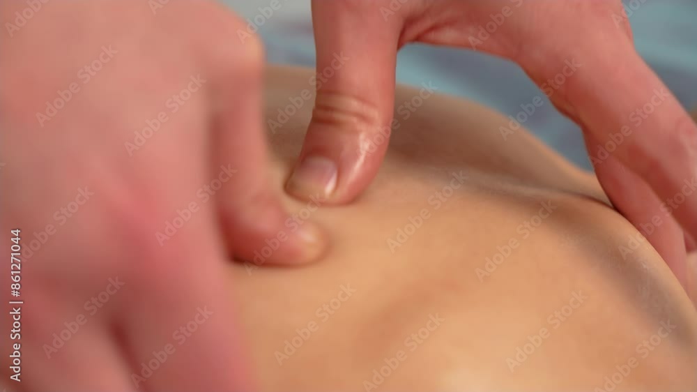 Close up top view of unrecognizable man pediatric masseuse making therapeutic massage on back to teen boy in clinic. Rehabilitation massage on back to boy in hospital Close up top view of unrecognizable man pediatric masseuse making therapeutic massage on back to teen boy in clinic. Rehabilitation massage on back to boy in hospital