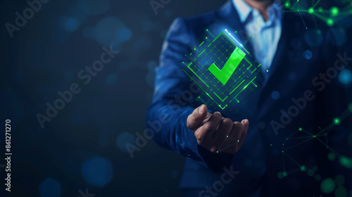 Businessman holding a virtual check mark icon on a digital screen photo