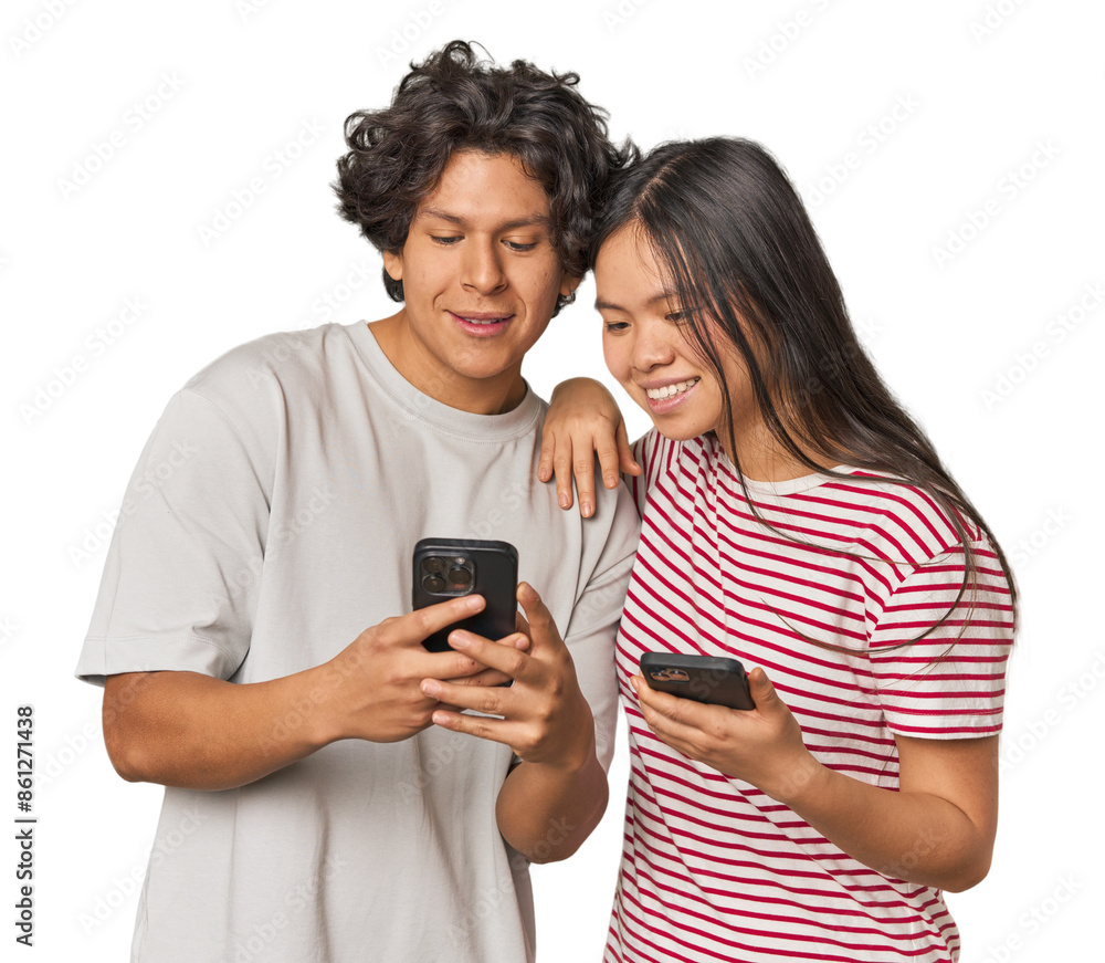 Multiracial young couple engaged with smartphones in studio Multiracial young couple engaged with smartphones in studio