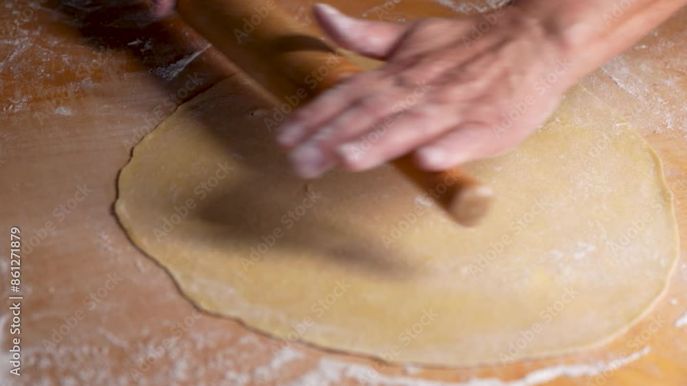 Close up of woman rolling dough with rolling pin Close up of woman rolling dough with rolling pin