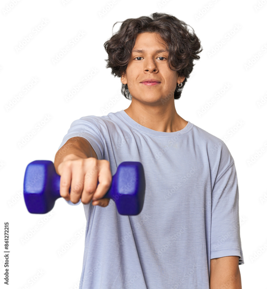 Young Latino man lifting weights in studio Young Latino man lifting weights in studio