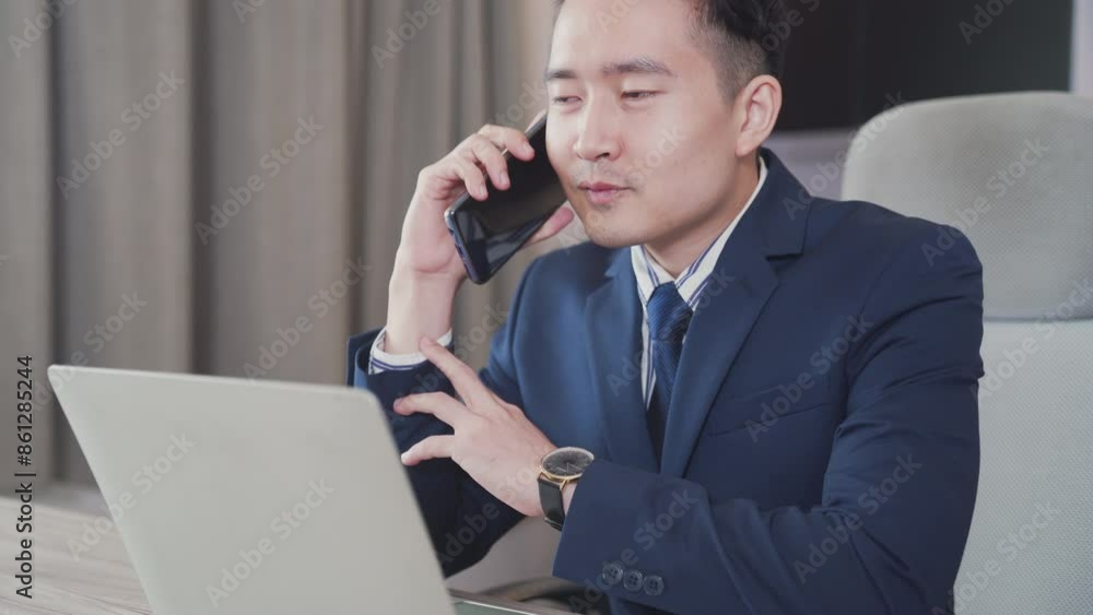 Business people. Businessman using laptop and mobile phone. Cheerful businessman using cellphone for communication.