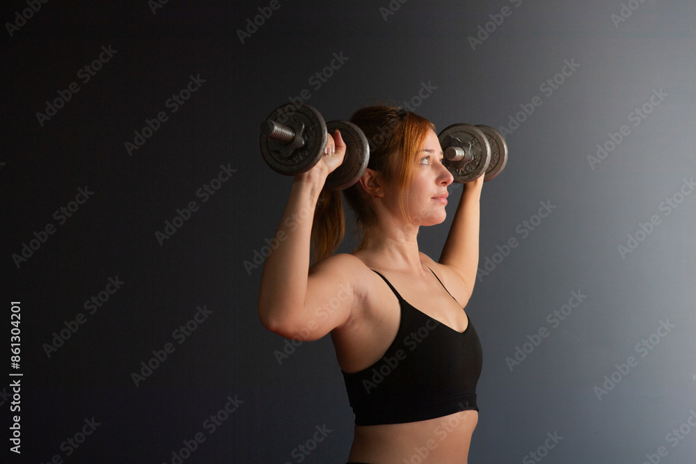 Fitness Girl In Fashion Sportswear. Woman in black sports clothes exercising with resistance band in studio. Fitness Girl In Fashion Sportswear. Woman in black sports clothes exercising with resistance band in studio.
