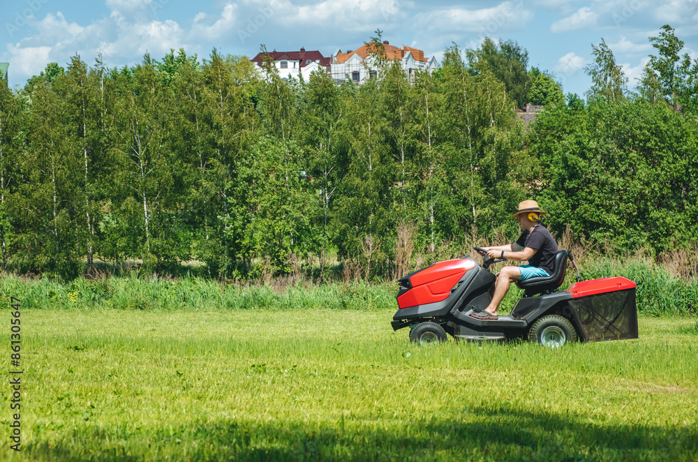 Man on lawn tractor mowing lawn on backyard. The red rider. The lawnmower tractor. High quality 4k footage Man on lawn tractor mowing lawn on backyard. The red rider. The lawnmower tractor. High quality 4k footage