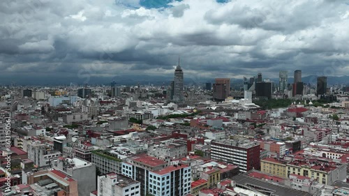Hyperlapse approaching the Torre Latinoamericana, passing over the Templo de Santo Domingo, on a moderately cloudy day. photo