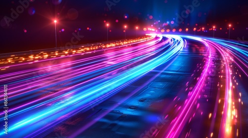 Abstract long exposure shot of car lights streaking on a highway at night.  The vibrant colors create a sense of speed and movement. © tinnakorn