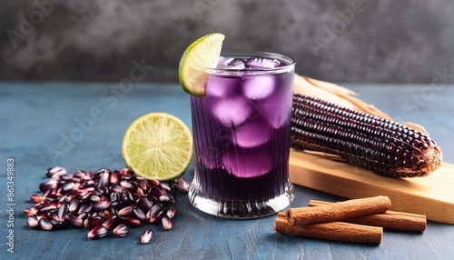 A glass of Peruvian Chicha Morada, a traditional drink made from purple corn, served with ice cubes and a slice of lemon