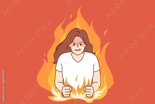 Nervous woman experiencing aggression due to psychological problems, standing in middle of burning flame. Girl aggression and disappointment are caused by bad character and defensiveness.