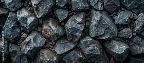 Background of black textured rocks with ample copy space image.