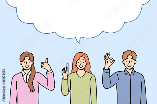 Business people make joint statement after discussion, standing under large dialogue cloud. Copy space inside dialogue bubble and office employees showing affirmative and recommendatory gestures